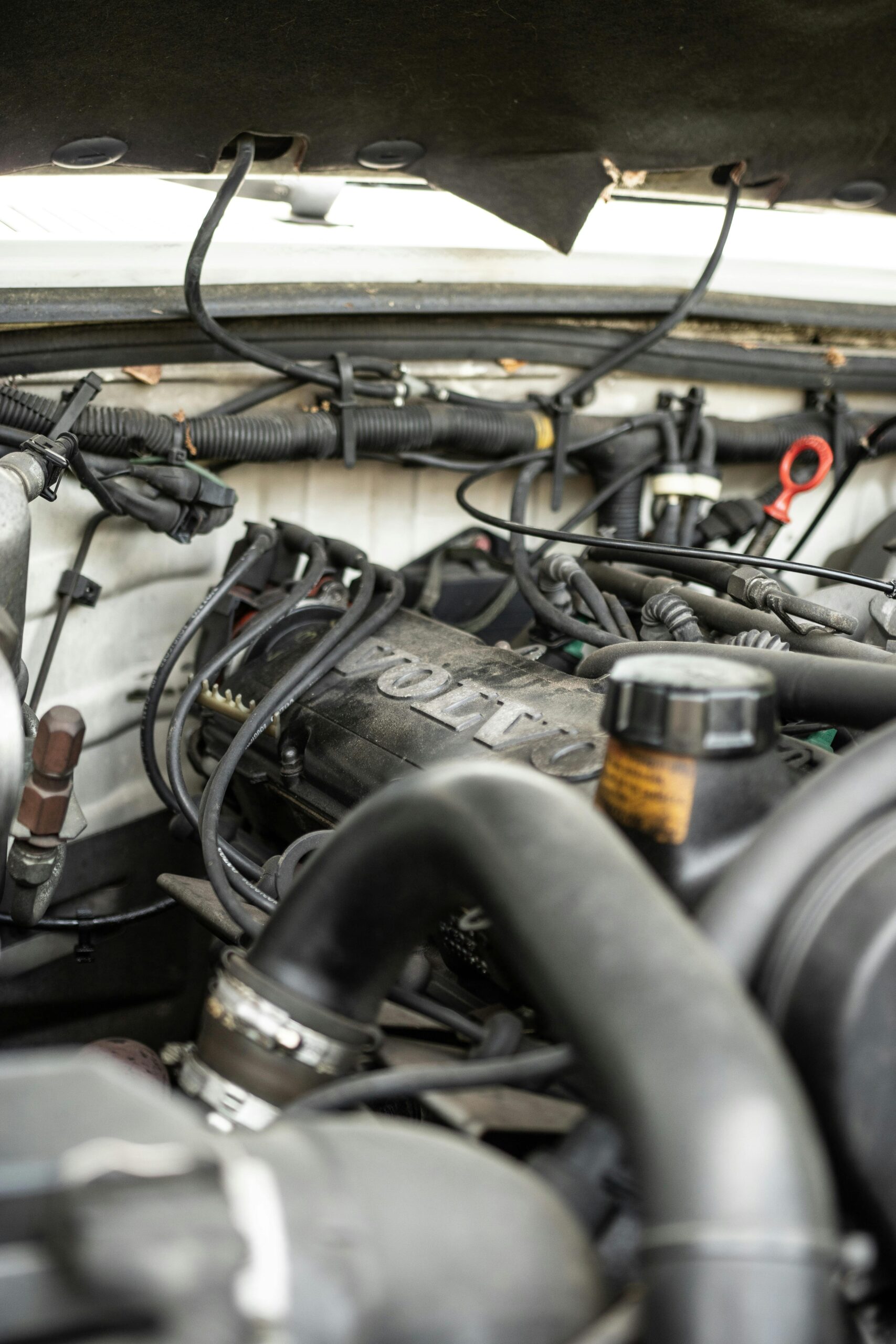 Detailed close-up of a car engine compartment with wires and components visible.